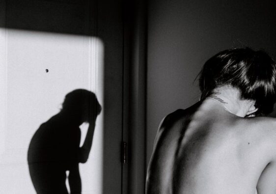 topless woman standing near shadow